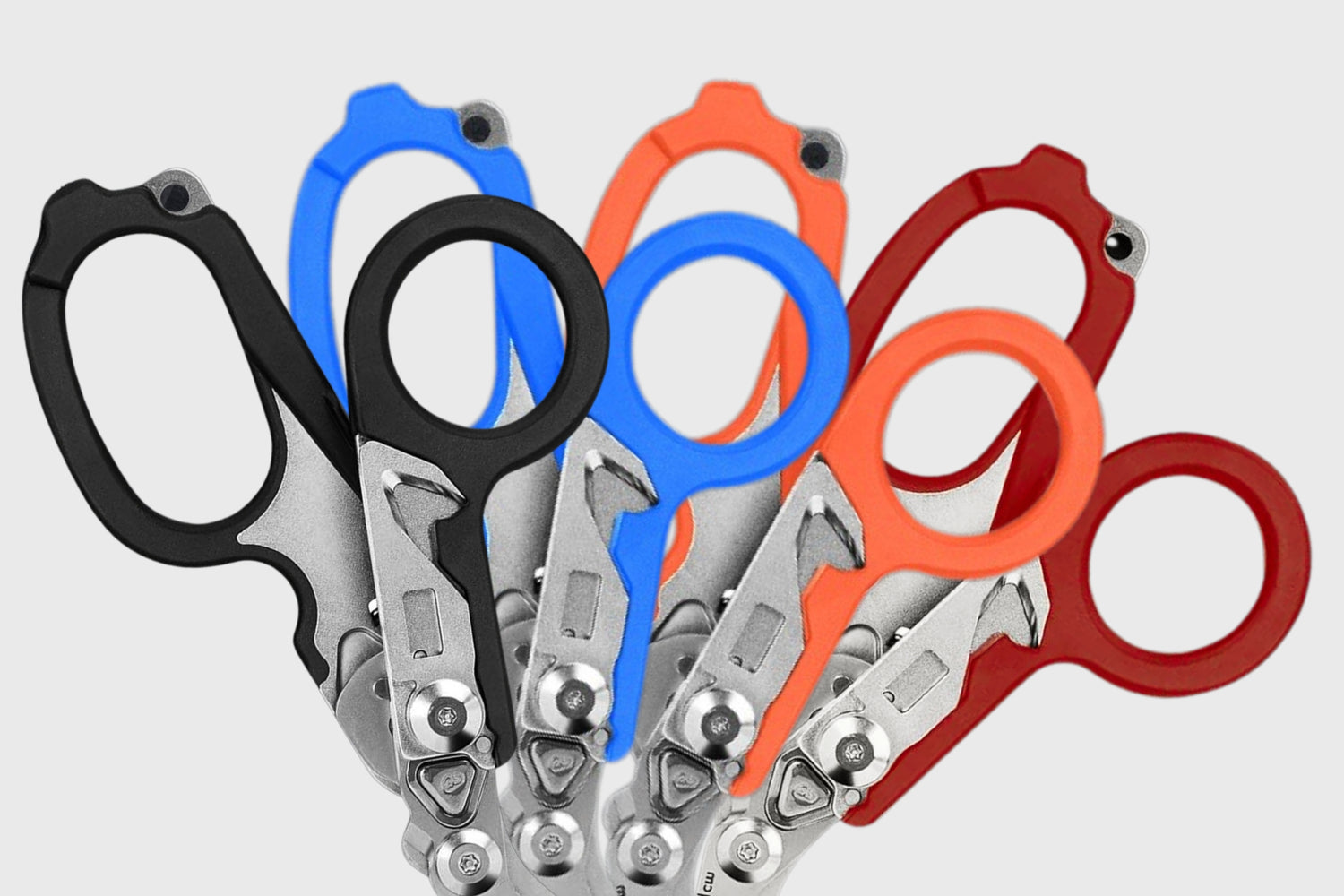 6-in-1 trauma shears in four handle colors: black, blue, orange, red