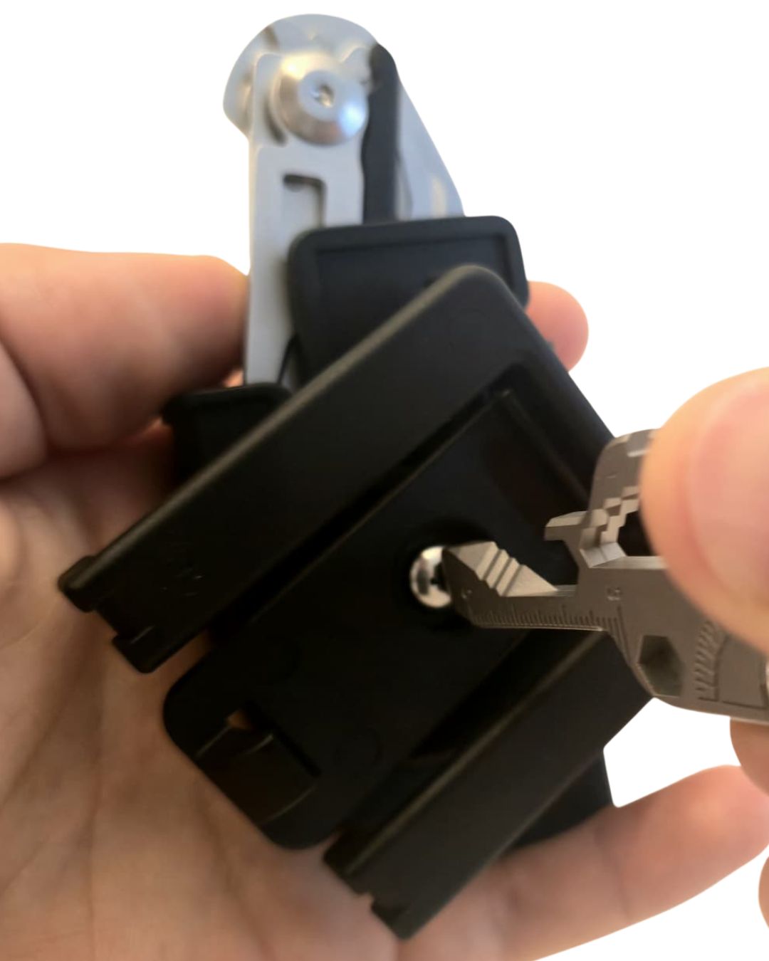 Holster step 3 (tighten): Tightening the holster pivot to lock the angle—secure, wobble-free carry.