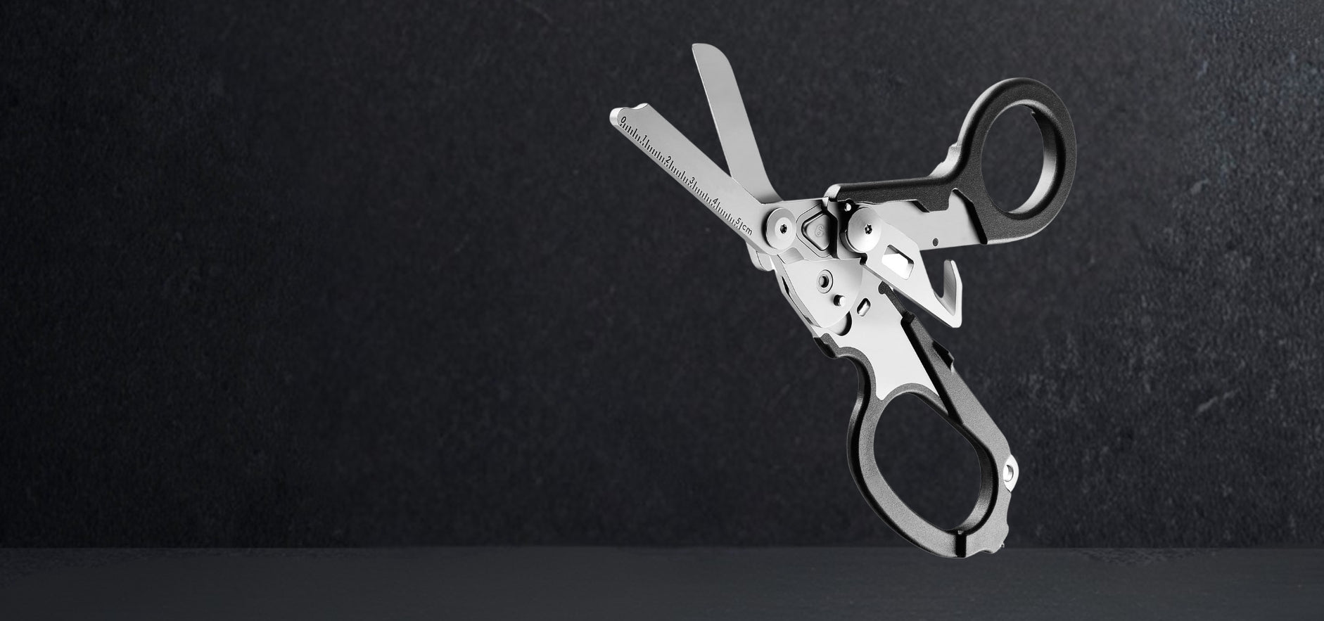 Foldable 6-in-1 trauma shears in 420HC steel on black background